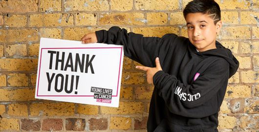 Sofyan holding a thank you sign