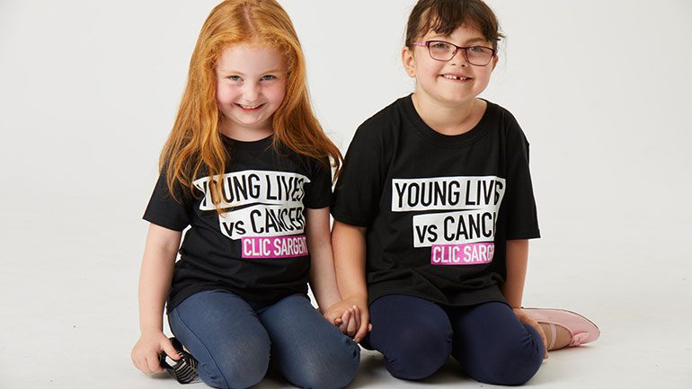 A young cancer patient we supported, holding hands with her sister