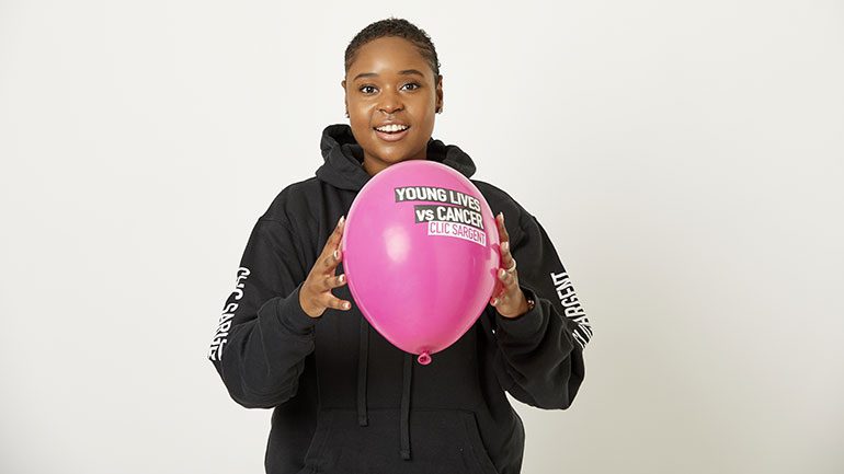 Michaela, a young person supported by CLIC Sargent, holding a balloon