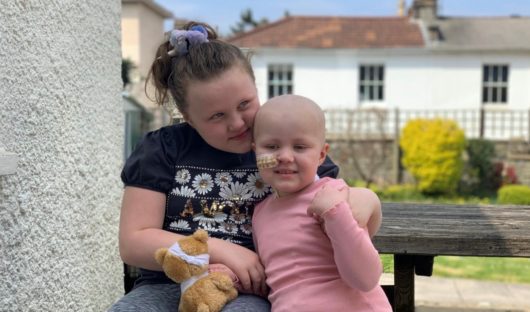 Evie with her older sister Millie after having her bone marrow transplant