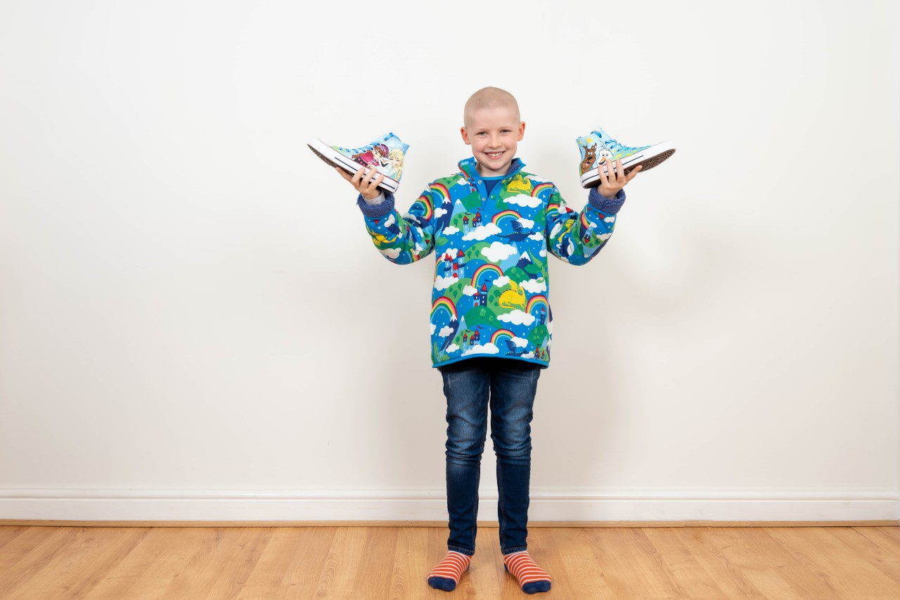Henry smiling with his Supershoes