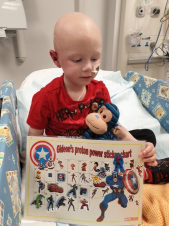 Gideon during treatment looking at his 'Proton Power Sticker Chart'