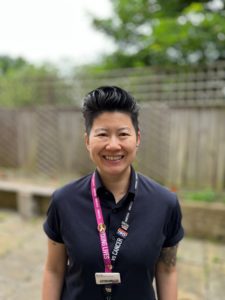 Lyn Soh wearing a lanyard with an NHS rainbow badge on it