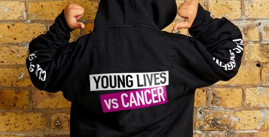 Black hoodie with Young Lives vs Cancer on reverse